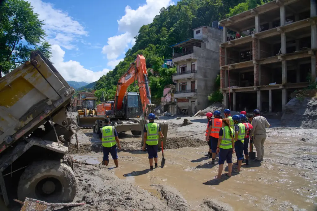 Earthmovers clear the debris from flash flooding in Nepal's Nuwakot district.