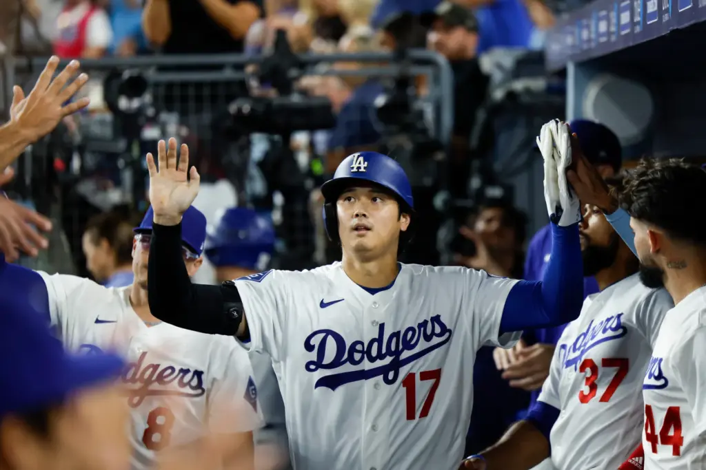 Dodgers star Shohei Ohtani is greeted by teammates in the...