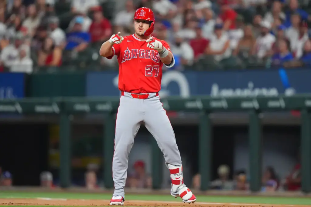 Angels’ Mike Trout points to the dugout after hitting a...