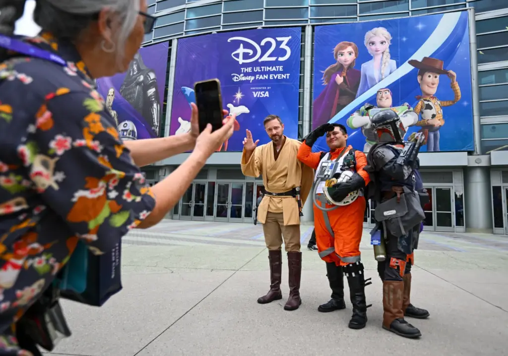 Debbie Ishida takes a picture of Ryan Sutter, dressed as...