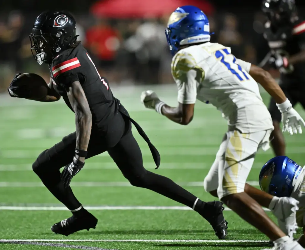 Centennial wide receiver Quentin Hale (1) makes the catch as...