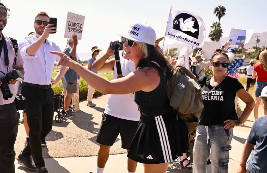A protester yells at pro-Trump supporters in front of Trump...