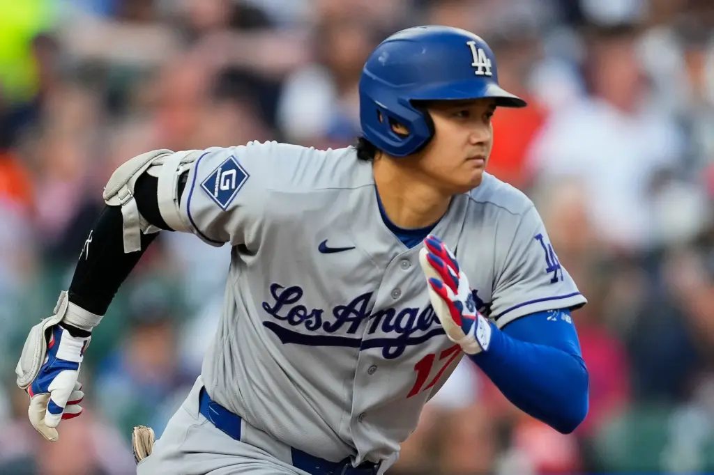 Dodgers star Shohei Ohtani runs out a ground out during...