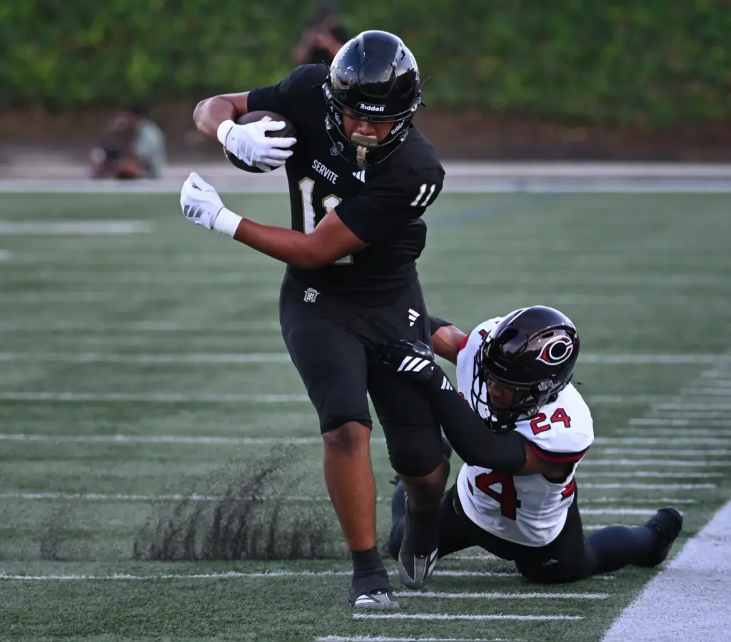 Serviteâs Mataua Niumata (11) holds onto the ball as Centennialâs...