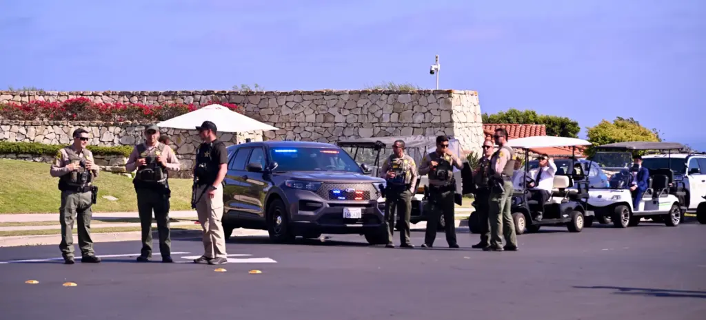Los Angeles County Sheriffs and Secret Service stand guard in...