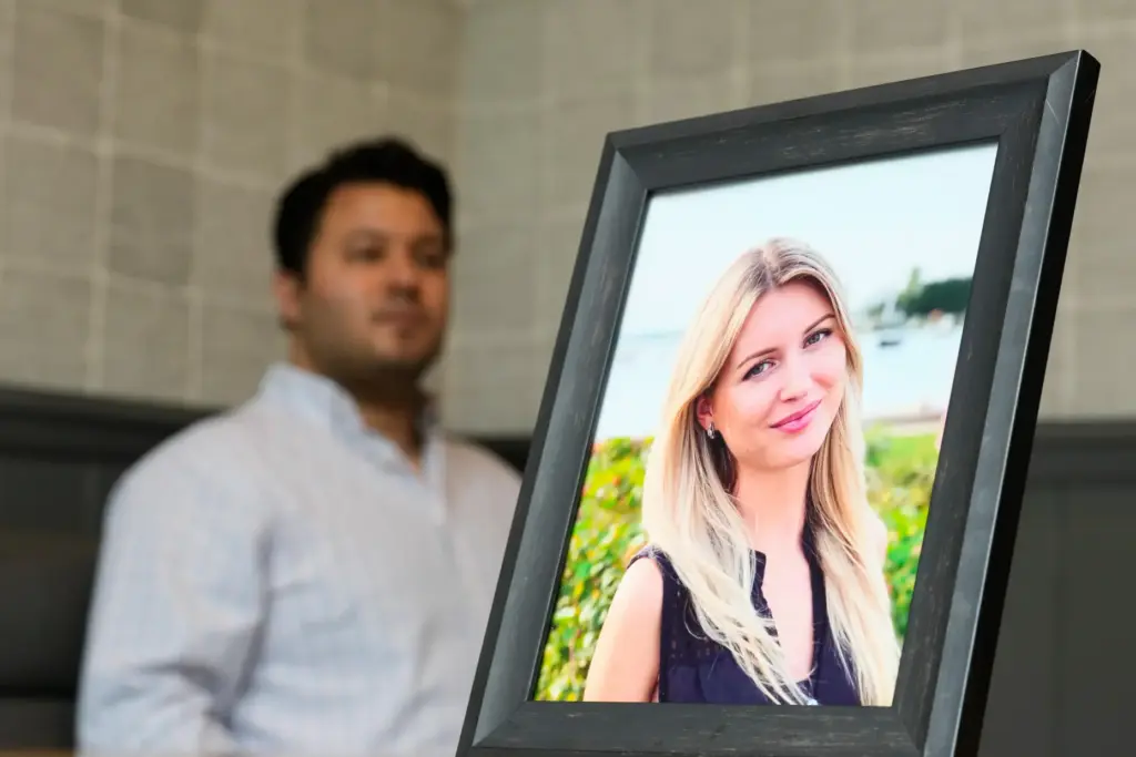 Harold Jezler poses for a picture with a photo of...