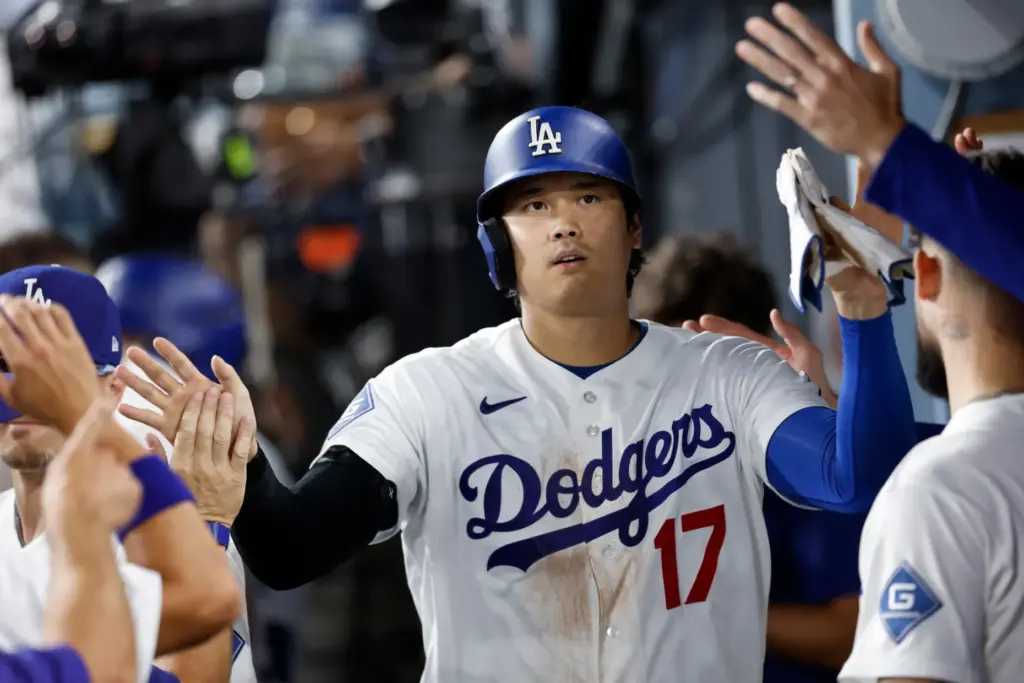 Dodgers star Shohei Ohtani is greeted by teammates in the...
