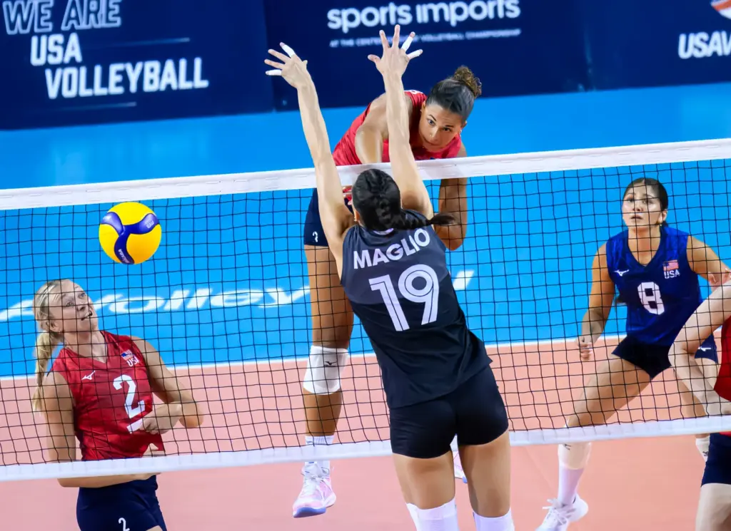 Team USAâs Avery Skinner, center, goes for the kill past...