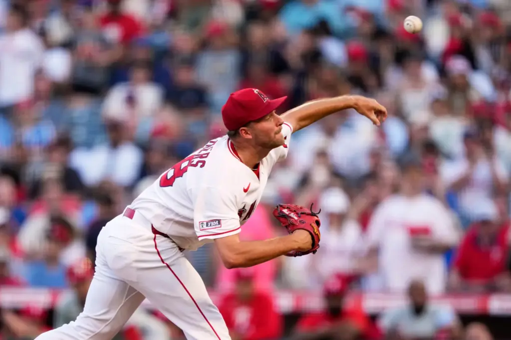 Angels starting pitcher Reid Detmers throws to the plate during...