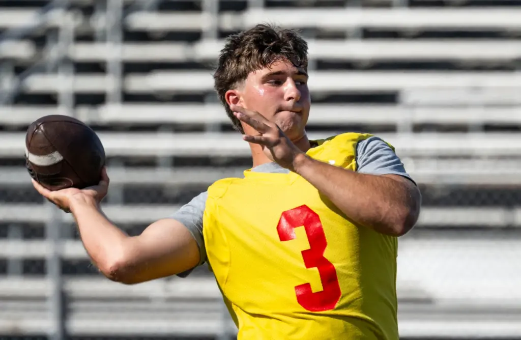 Mission Viejo High School quarterback Brett Burnor practices with the...