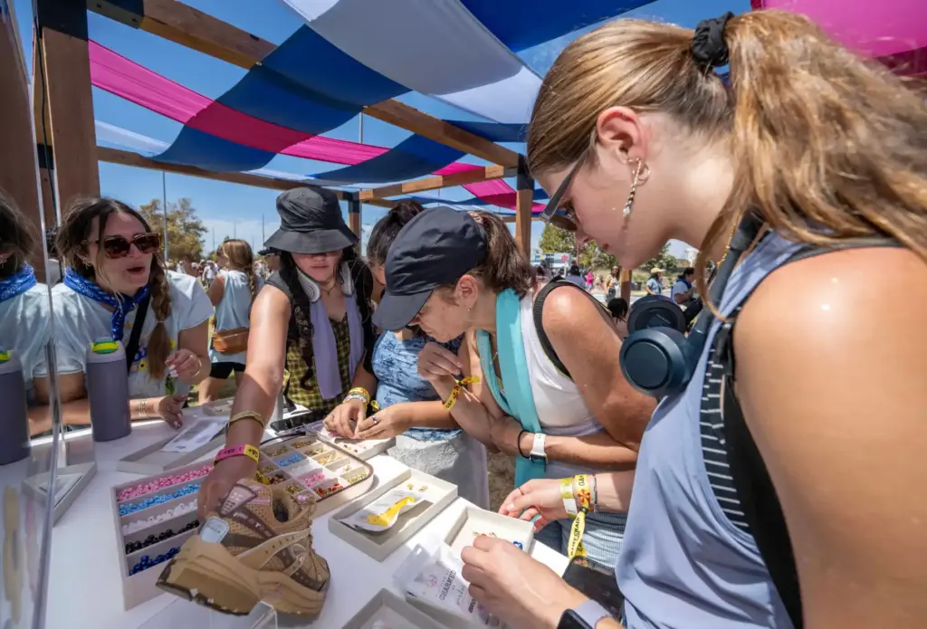 Festivalgoers design unique charms in the Shoe Charm Bar at...