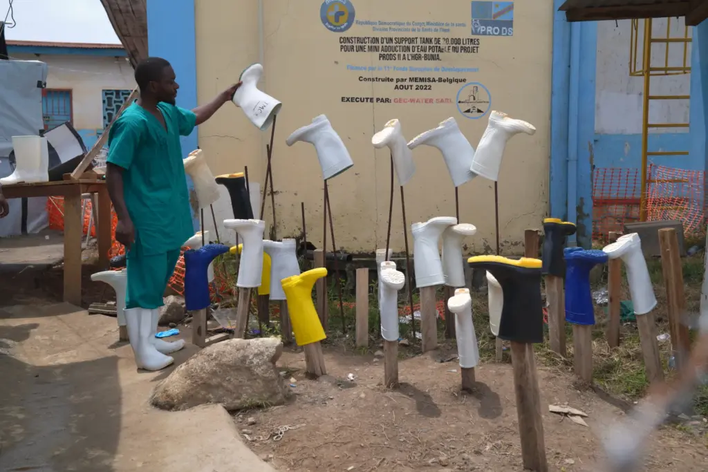 A health worker dries boots that were washed to prevent the spread of Ebola.