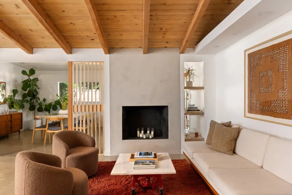 A minimalist fireplace with an integrated shelving niche anchors the...