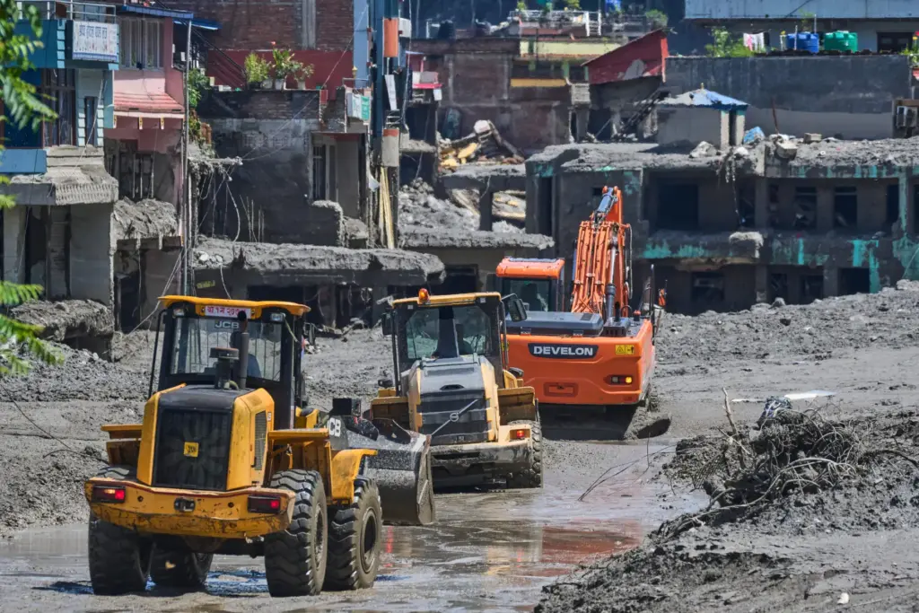 Earthmovers clear the debris of flash flooding in Nepal's Nuwakot district.