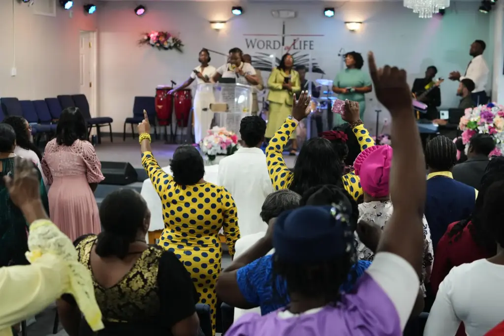 Members of the Word of Life Center sing and pray during a service.