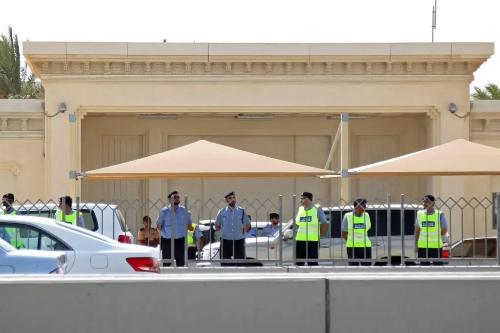 FILE – Qatar’s police surround the U.S. embassy during a...