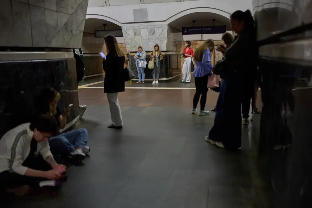 Commuters shelter at Palats Sportu metro station during an air raid alarm.