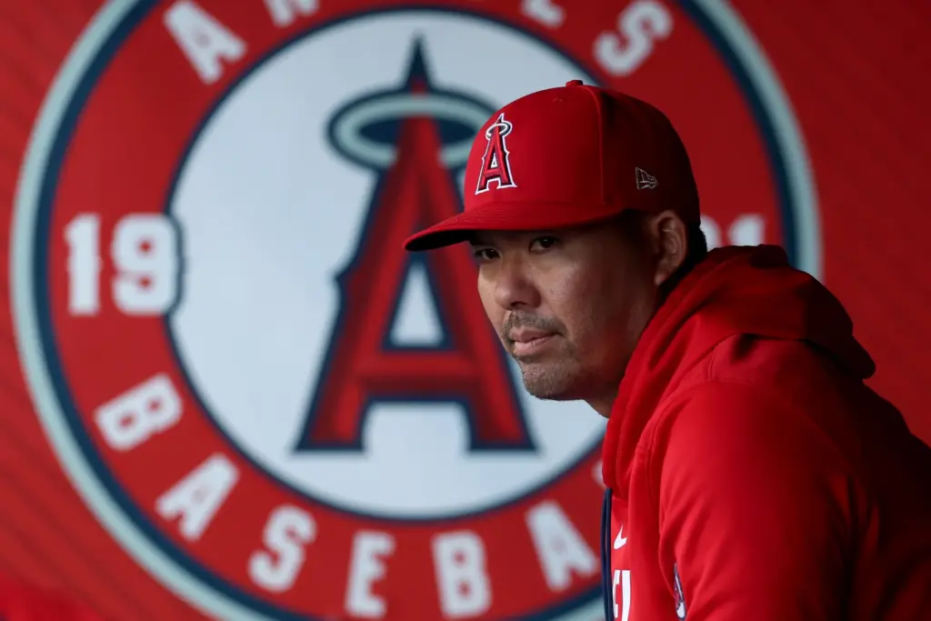 Angels manager Kurt Suzuki looks on before a game against...