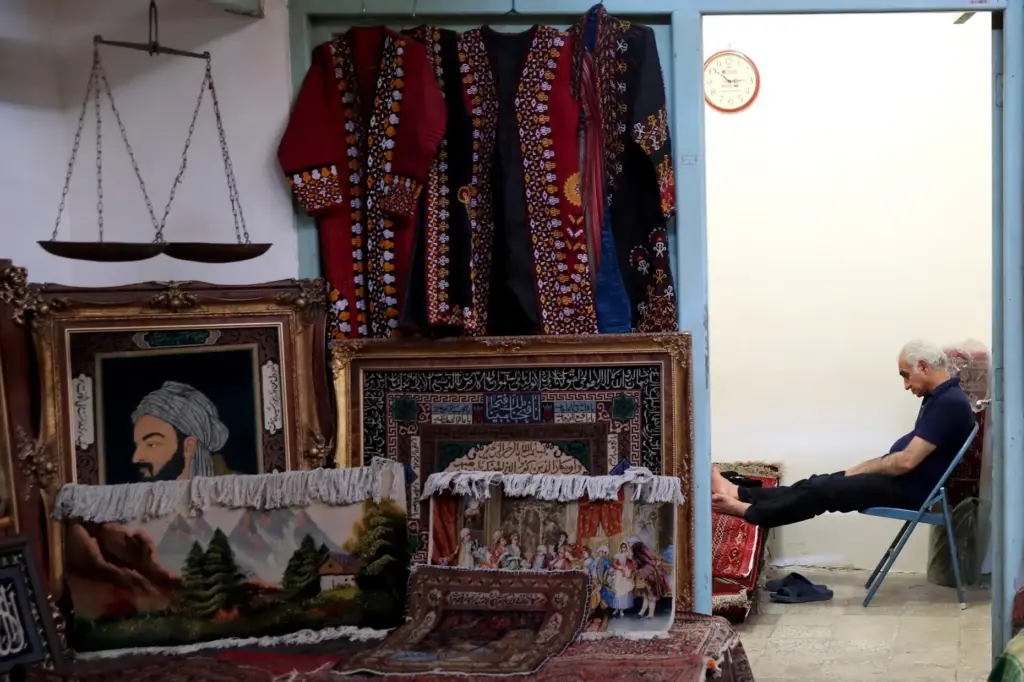 A carpet seller sits at his shop in the old main bazaar in Tehran, Iran.