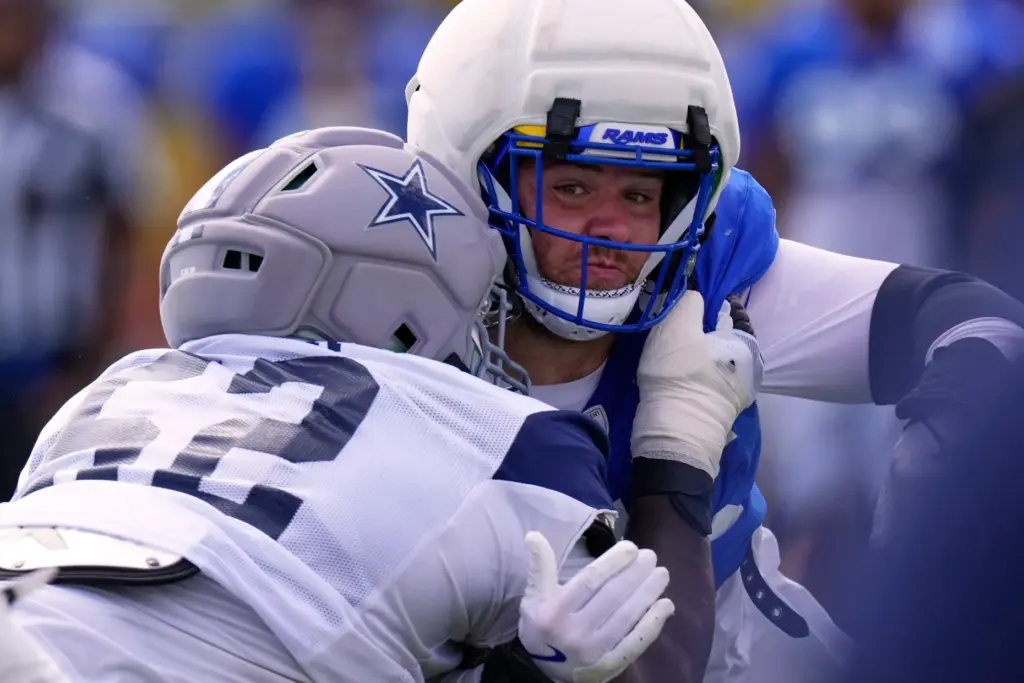 Rams defensive end Braden Fiske, right, tries to get past...
