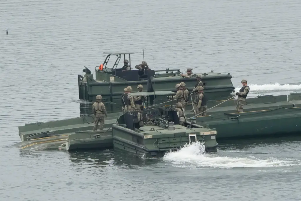 U.S. Army soldiers try to dismantle a floating bridge during a training exercise on a Yeoncheon river.