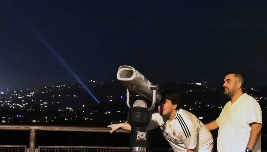 Visitors to Griffith Observatory in Los Angeles use a spotting...