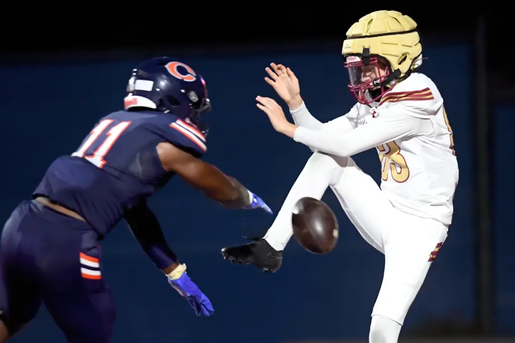 Oaks Christianâs Kaden Nesen (83) has his punt blocked by...
