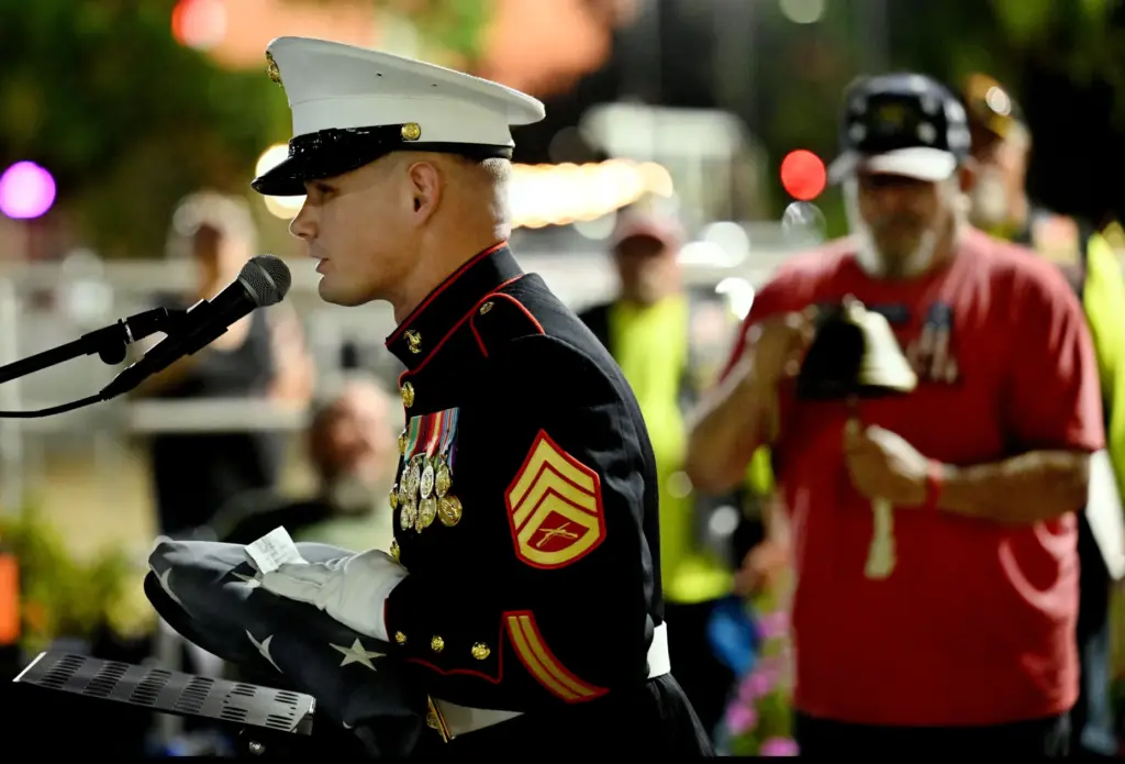 Marine Staff Sgt. Collier Zelenka reads the names of the...