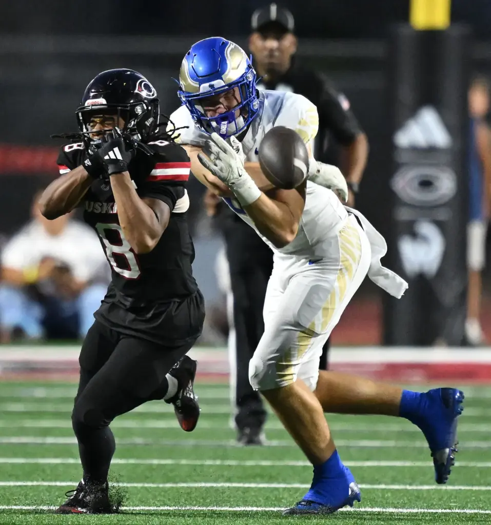Centennial defensive back Dean Gibson (8) breaks up a pass...