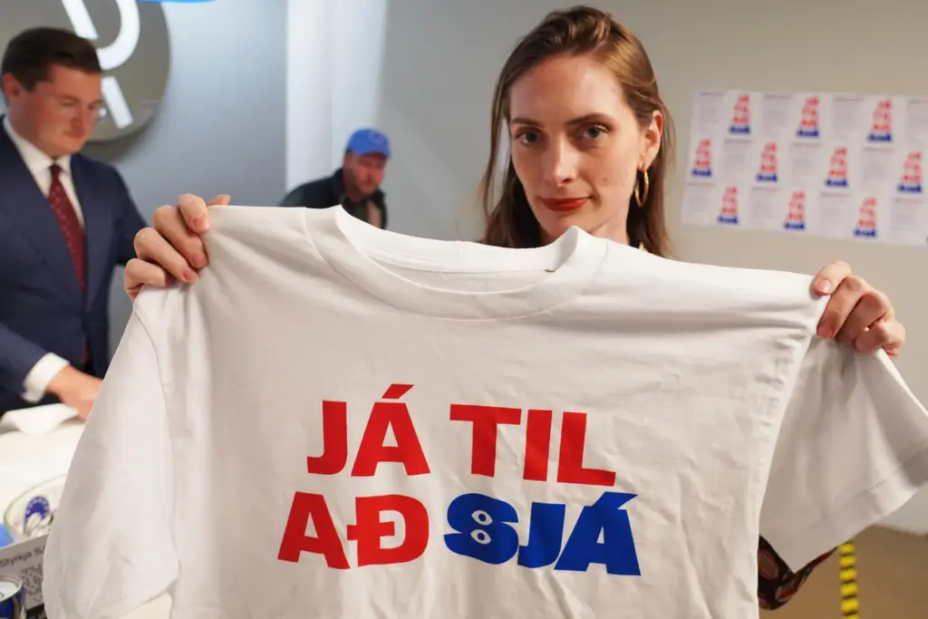 A supporter holds a t-shirt reading, “Yes to see”, at...