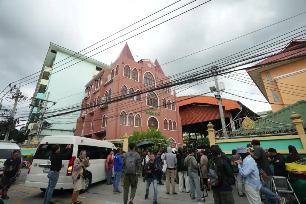 A crowd gathers outside the school.