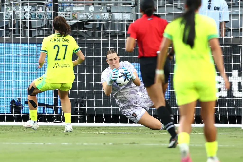 Angel City FC goalkeeper Angelina Anderson, bottom, makes a save...