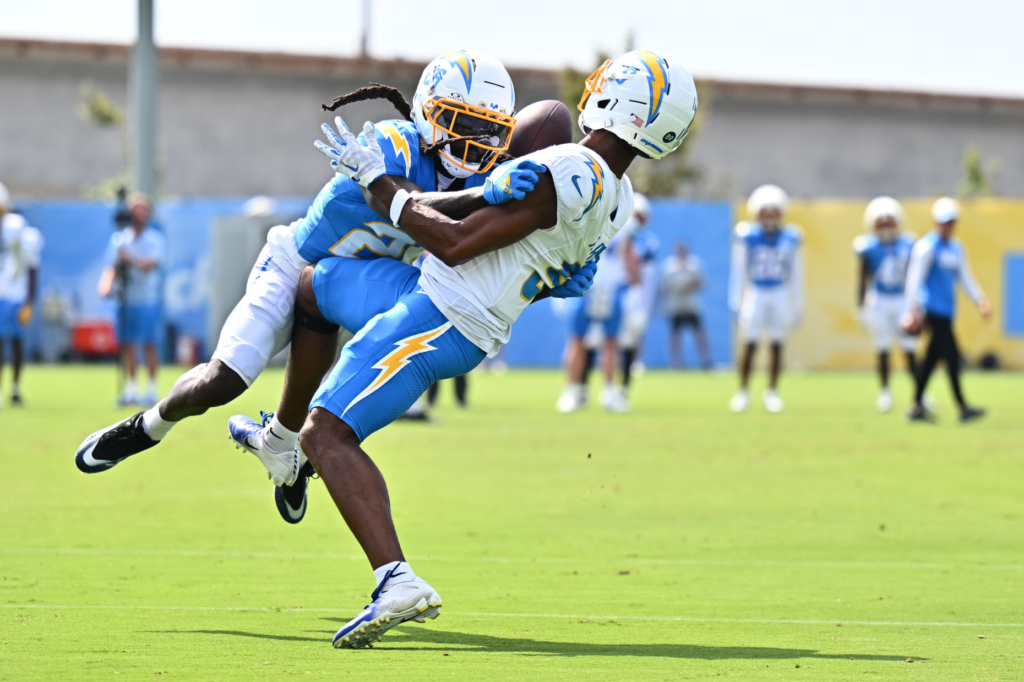 Chargers wide receiver Tre Harris, right, makes a catch while...