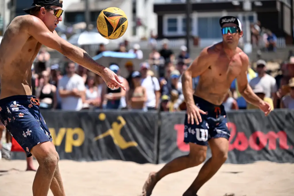 Troy Field and Ryan Wilcox set the ball against Evan...
