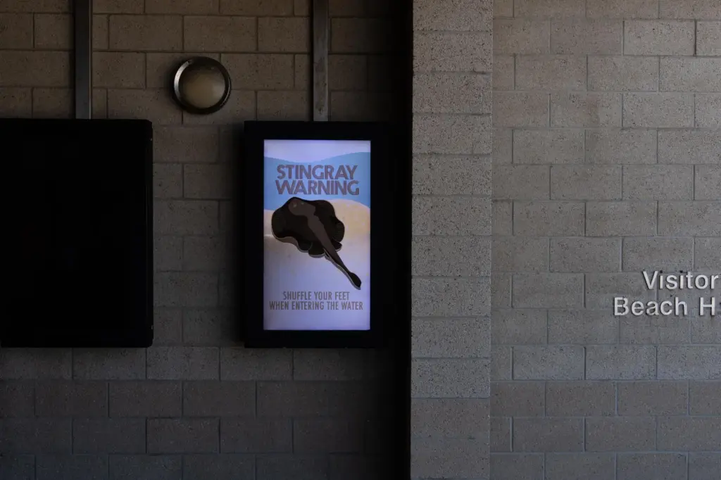 A stingray warning is displayed at Bolsa Chica State Beach...