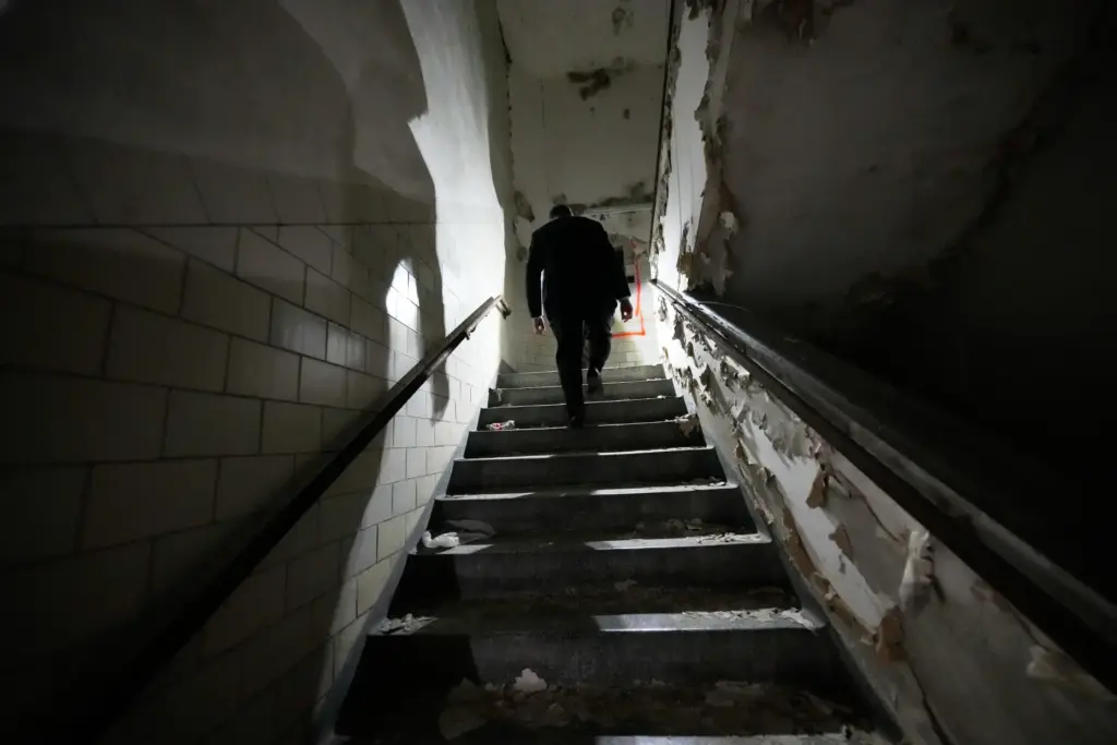 Tulane University president Michael A. Fitts walks up a stairwell...