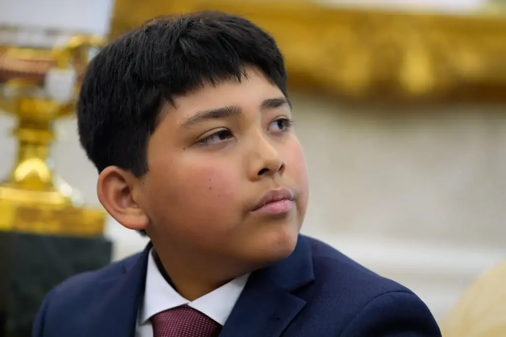 Nathaniel Rai listens as President Donald Trump meets with lifeguard...