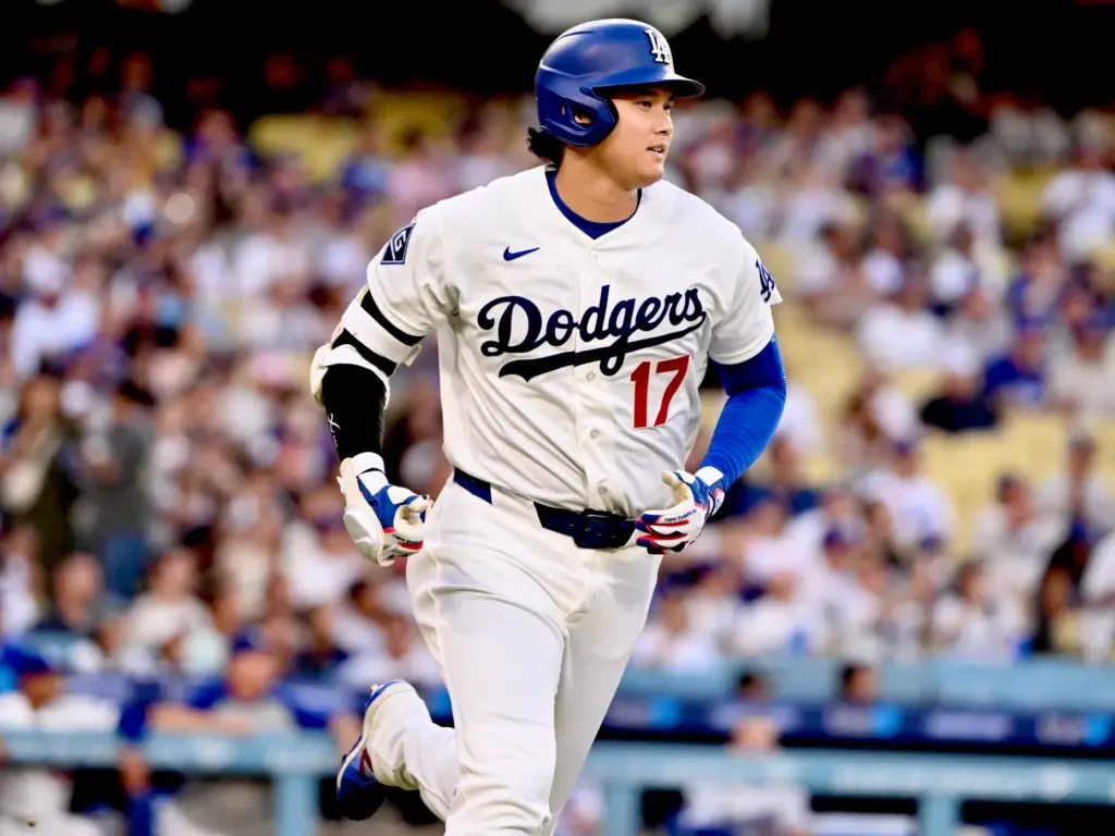 Dodgers star Shohei Ohtani runs after hitting a fly ball...