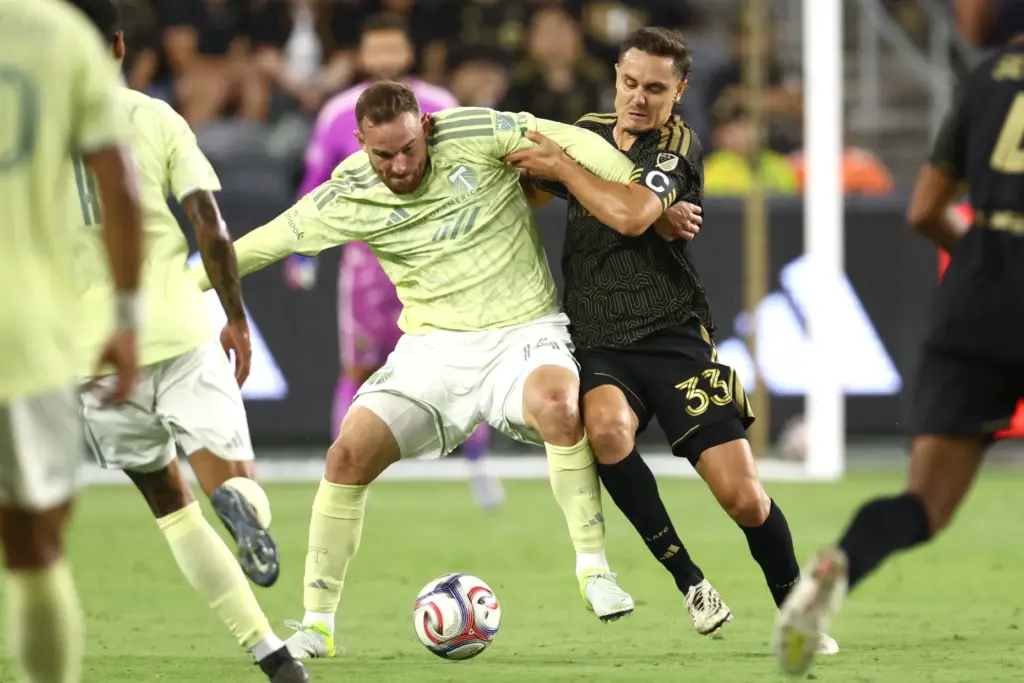 Los Angeles FC defender Aaron Long (33) battles for the...