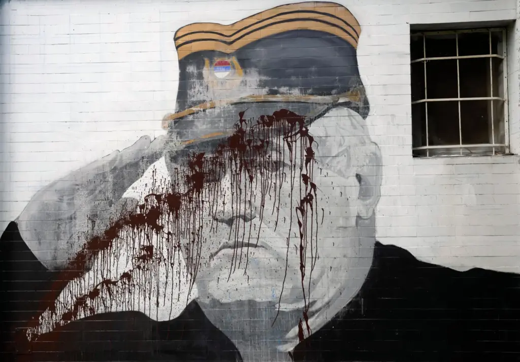 FILE – A mural of former Bosnian Serb military chief...
