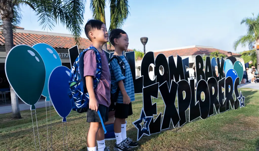 Camden and Kai Lee, from left, take a photo in...