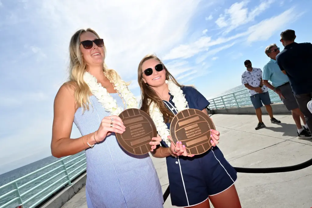 Taryn Brasher and Kristen Cruz hold their plaques after the...