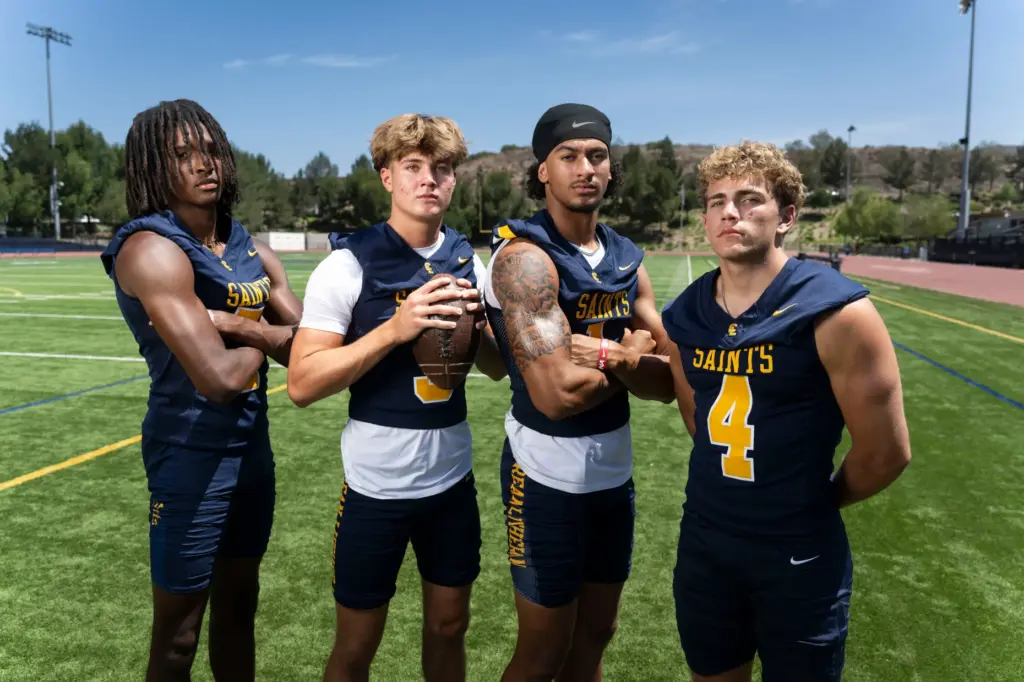 Crean Luthern High School football players Evan Mack, Caden Jones,...