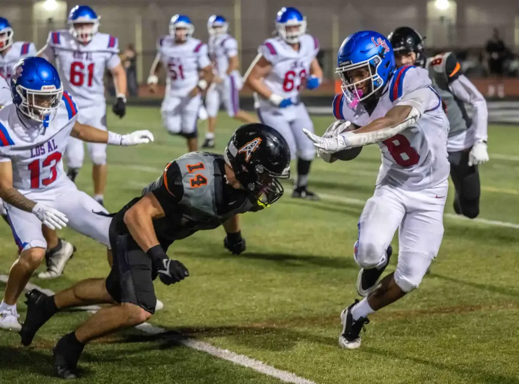 Los Alamitos running back Kamden Tillis (8) carries the ball...