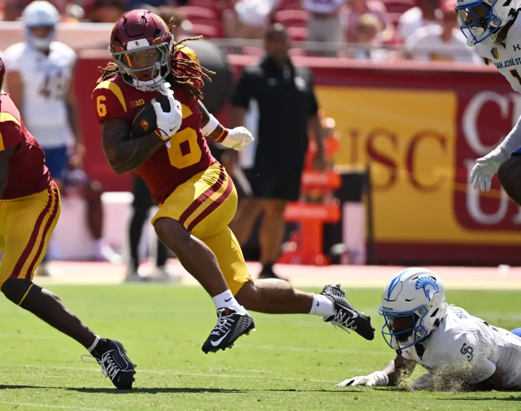Running back Deshonne Redeaux (6) of the USC Trojans runs...