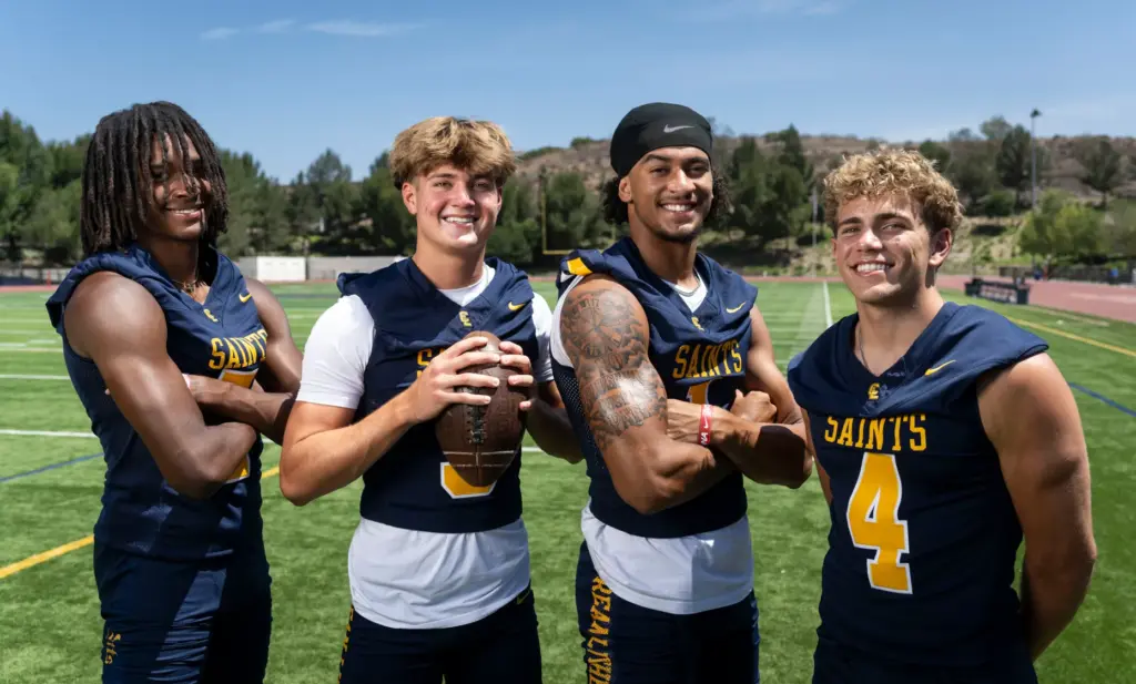 Crean Luthern High School football players Evan Mack, Caden Jones,...