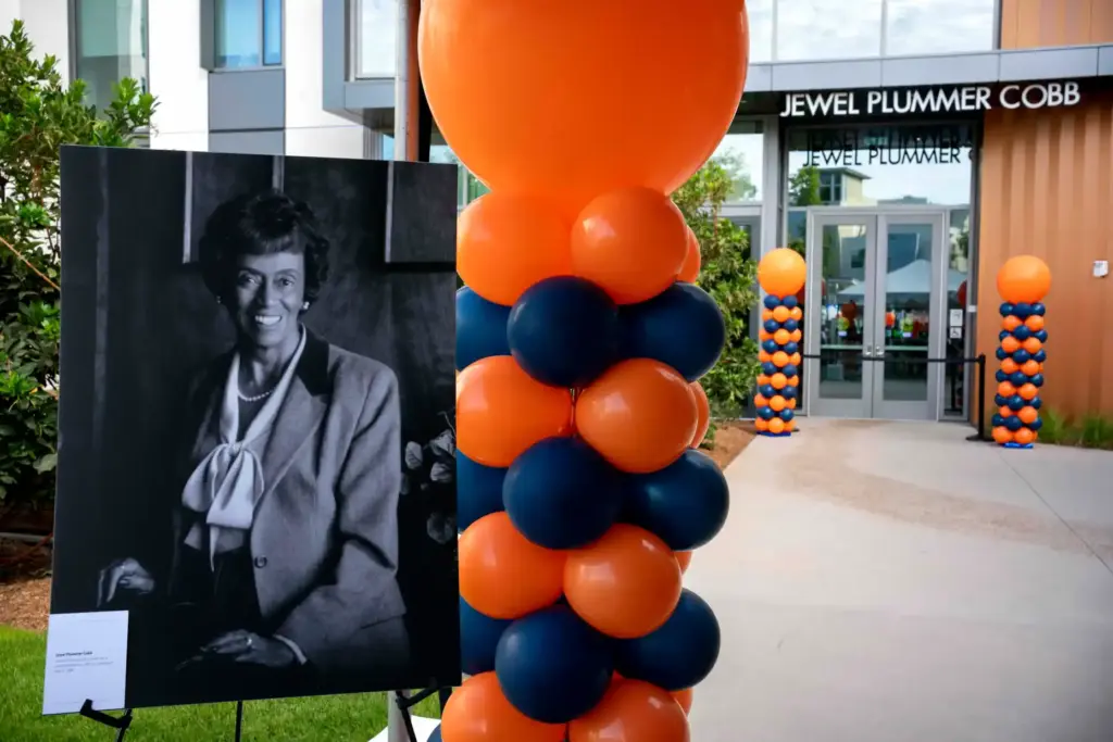 A portrait of Jewel Plummer Cobb sits beside the podium...