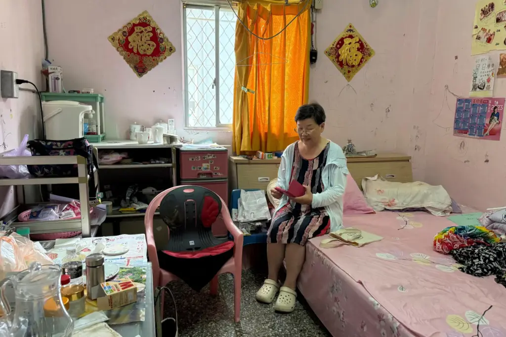 Mi Zhengrong sits in her room in Taipei, Taiwan.