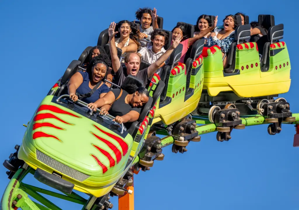 Fairgoers ride the Raptor Coaster during the opening day of...