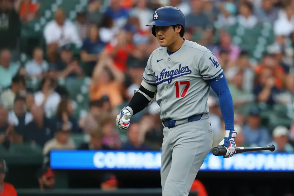 Dodgers star Shohei Ohtani reacts to striking out during the...